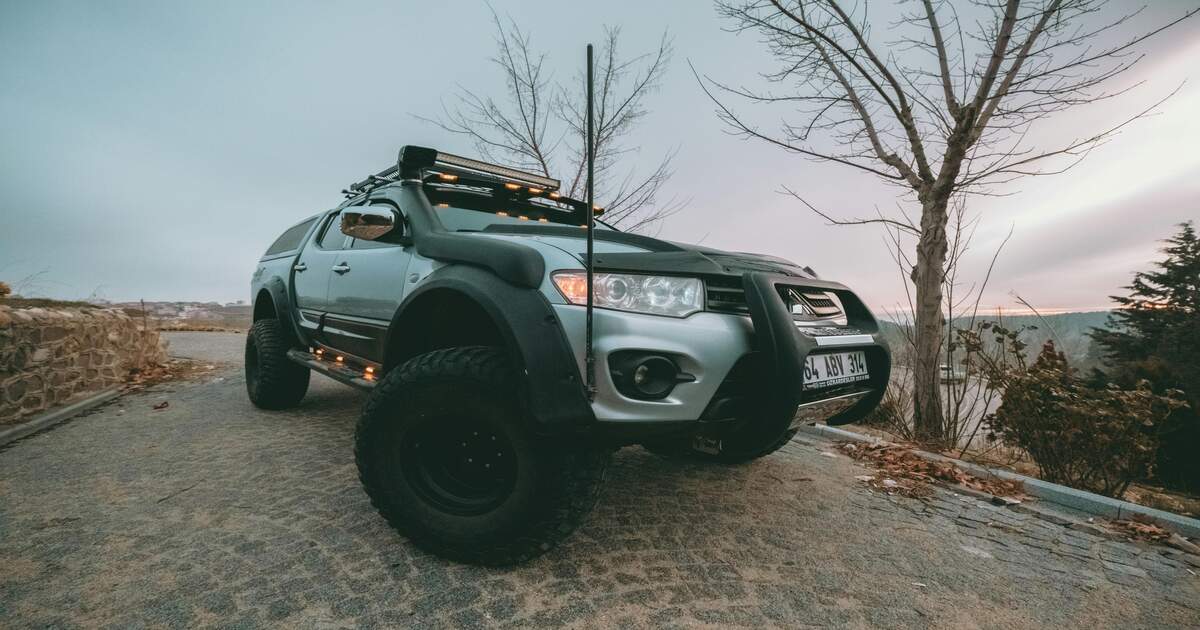 An 4x4 SUV with a snorkel on a hill.
