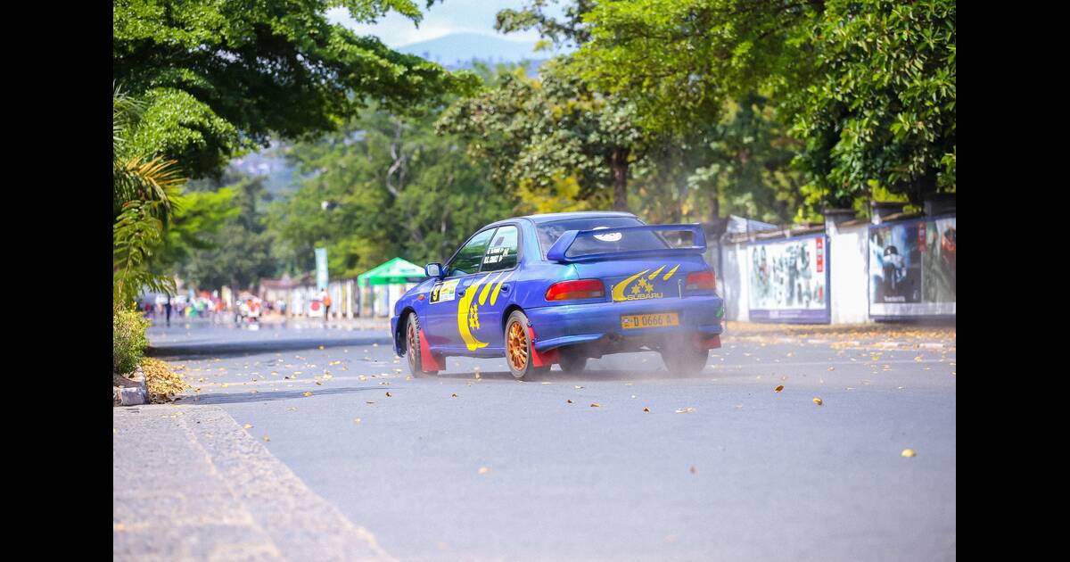 Blue car with high-quality struts and shocks on the road.