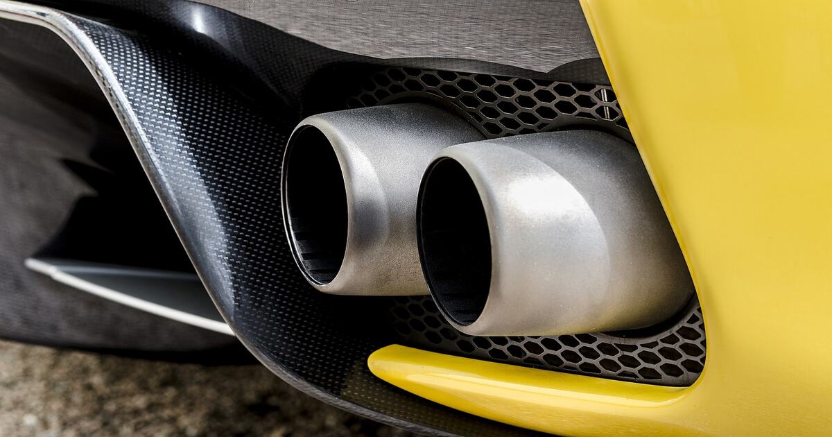 A performance exhaust on a yellow vehicle.
