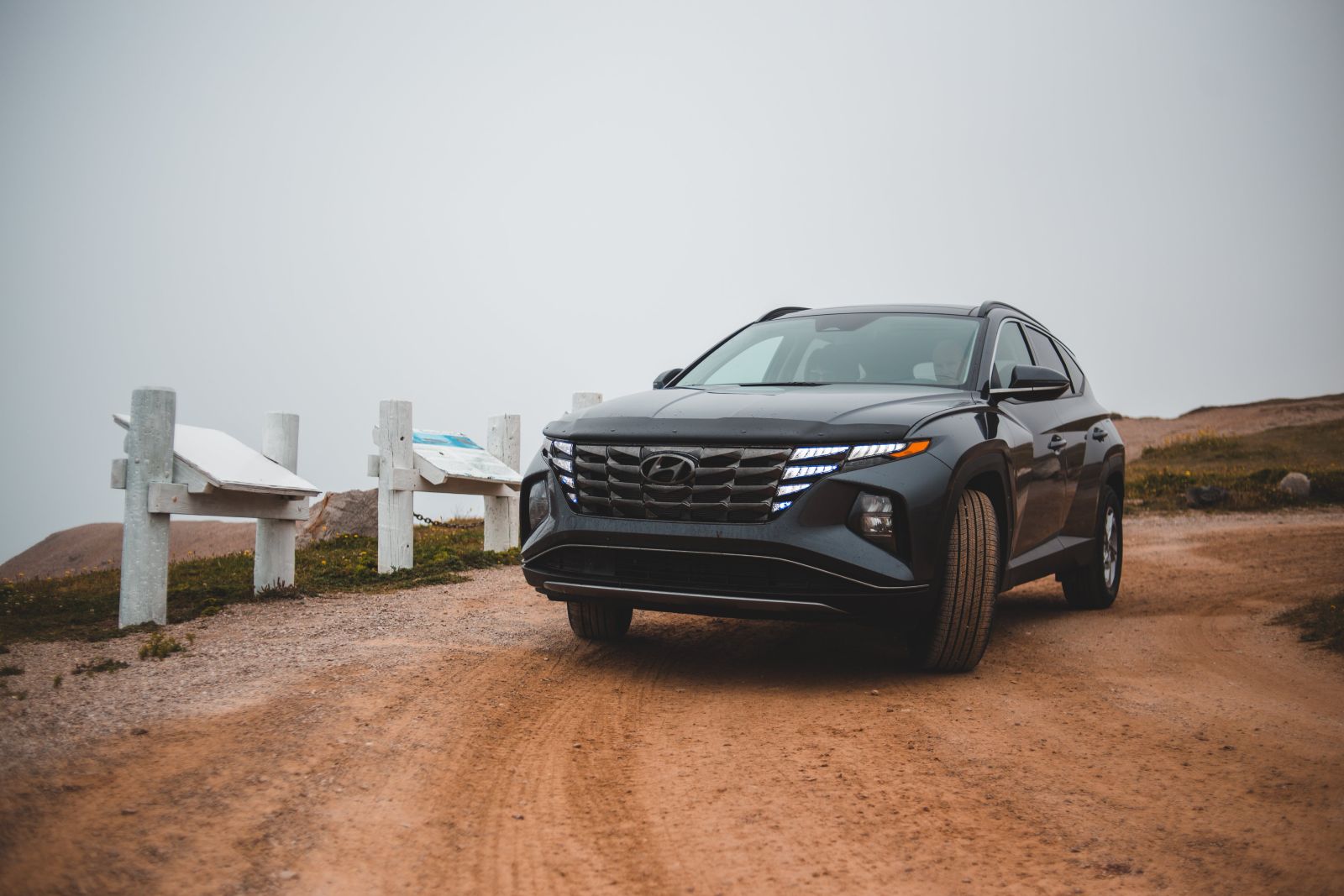 A car driving on a dirt road.