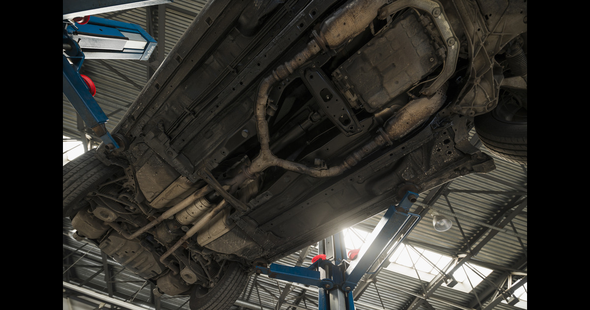 The undercarriage of a vehicle with a double-pipe 4WD exhaust system.