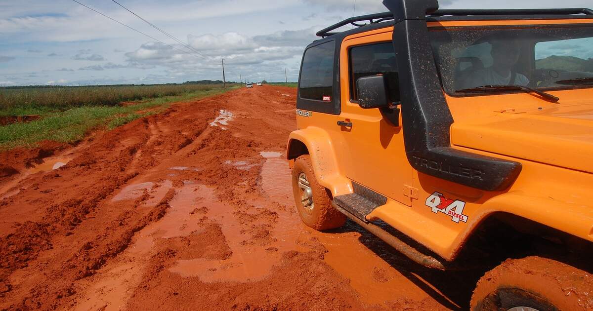 A vehicle with a snorkel on a muddy road.